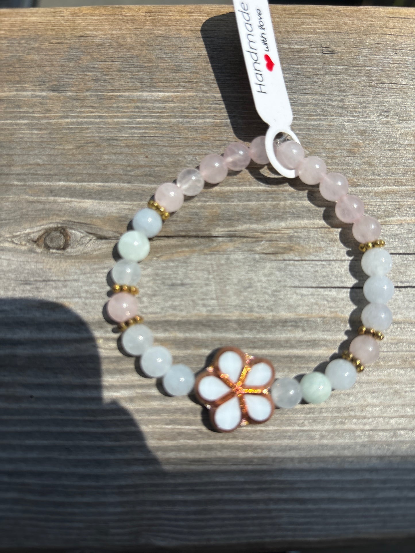 Aquamarine and rose quartz crystal bracelet- 7”. White/brass outline flower
